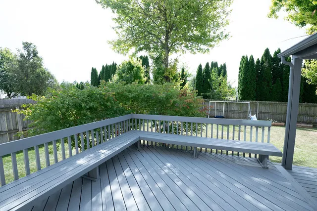 a view of a roof deck with wooden floor and fence