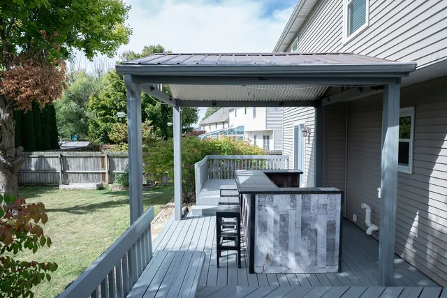 a view of a deck with a table and chairs with wooden floor and fence