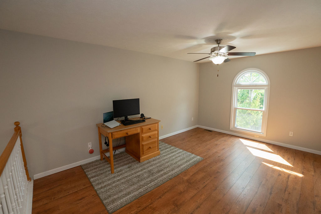 1708 Royal Pointe Drive Bloomington, IL 61704 - Photo 5 of 48 a living room with hardwood floor a ceiling fan and a window