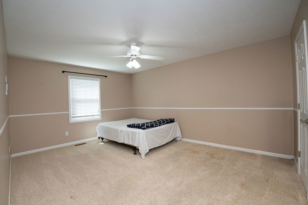 1708 Royal Pointe Drive Bloomington, IL 61704 - Photo 10 of 48 an empty room with windows and fan