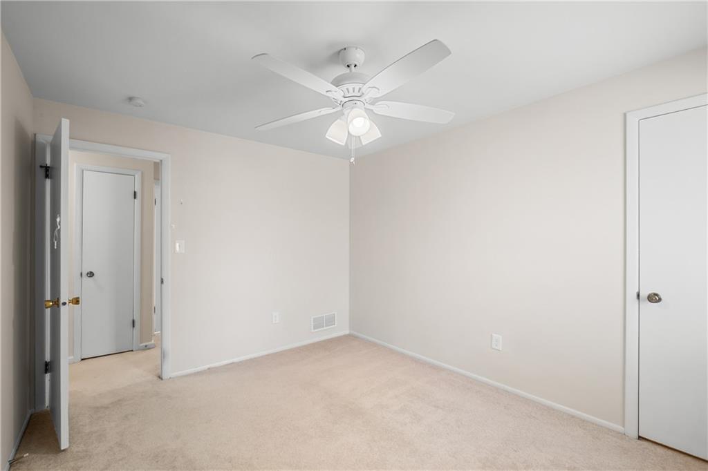 116 Fox Trot Drive Mars, PA 16046 - Photo 24 of 34 an empty room with a ceiling fan and a window