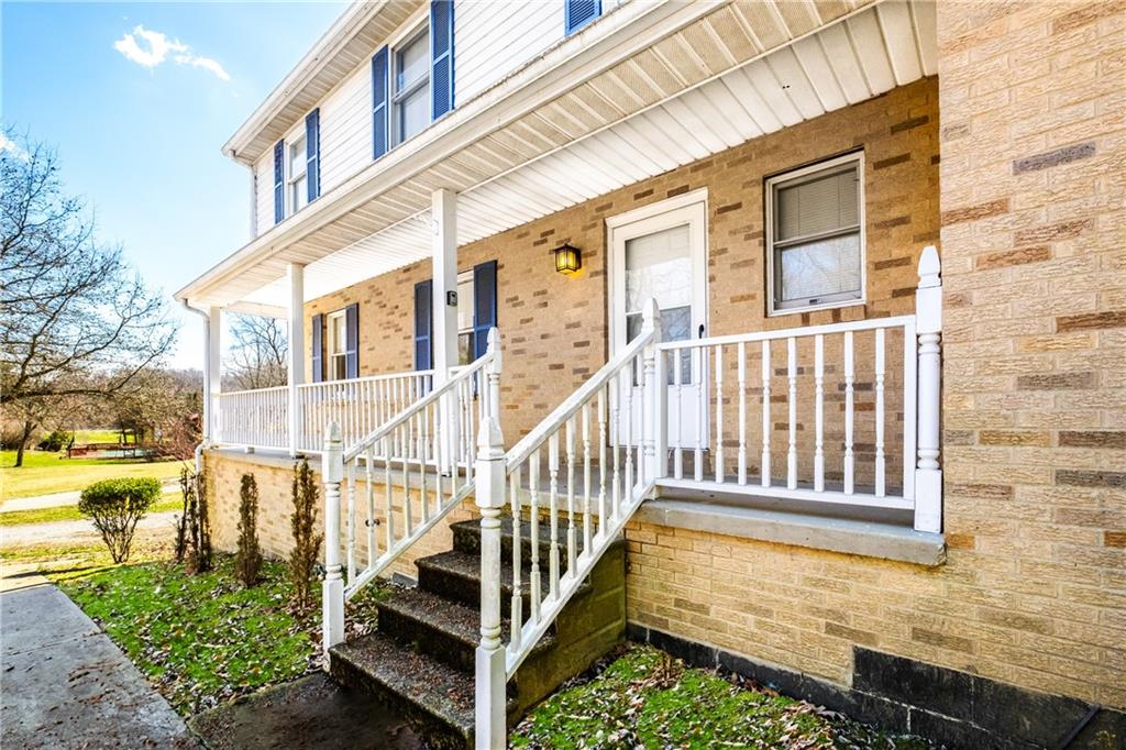 116 Fox Trot Drive Mars, PA 16046 - Photo 29 of 34 a view of a brick house with large windows and a small yard