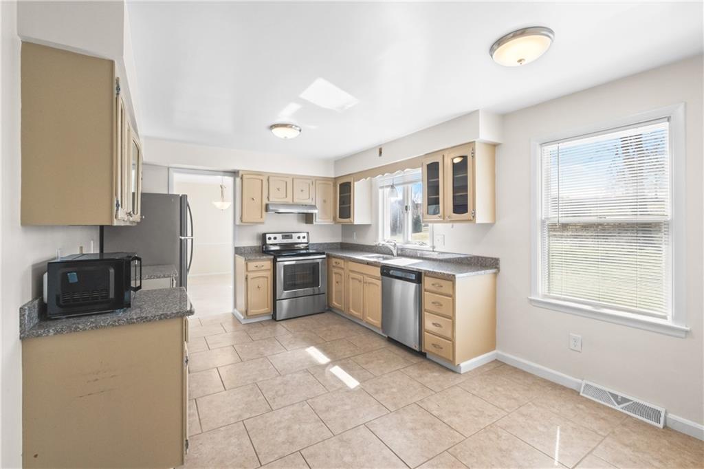 116 Fox Trot Drive Mars, PA 16046 - Photo 6 of 34 a kitchen with stainless steel appliances granite countertop a stove a sink and a refrigerator