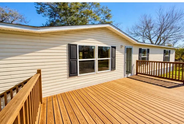 a view of a house with wooden deck