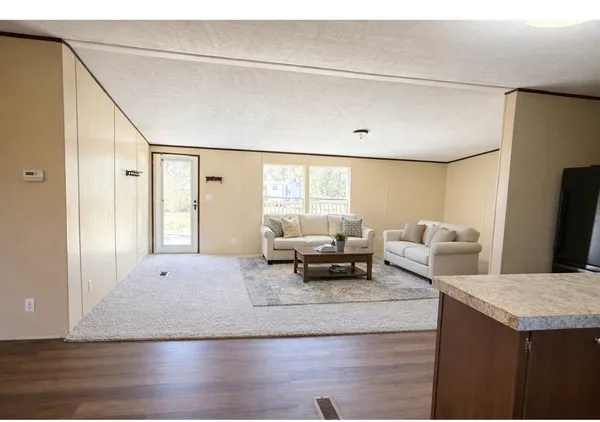a living room with furniture and large window
