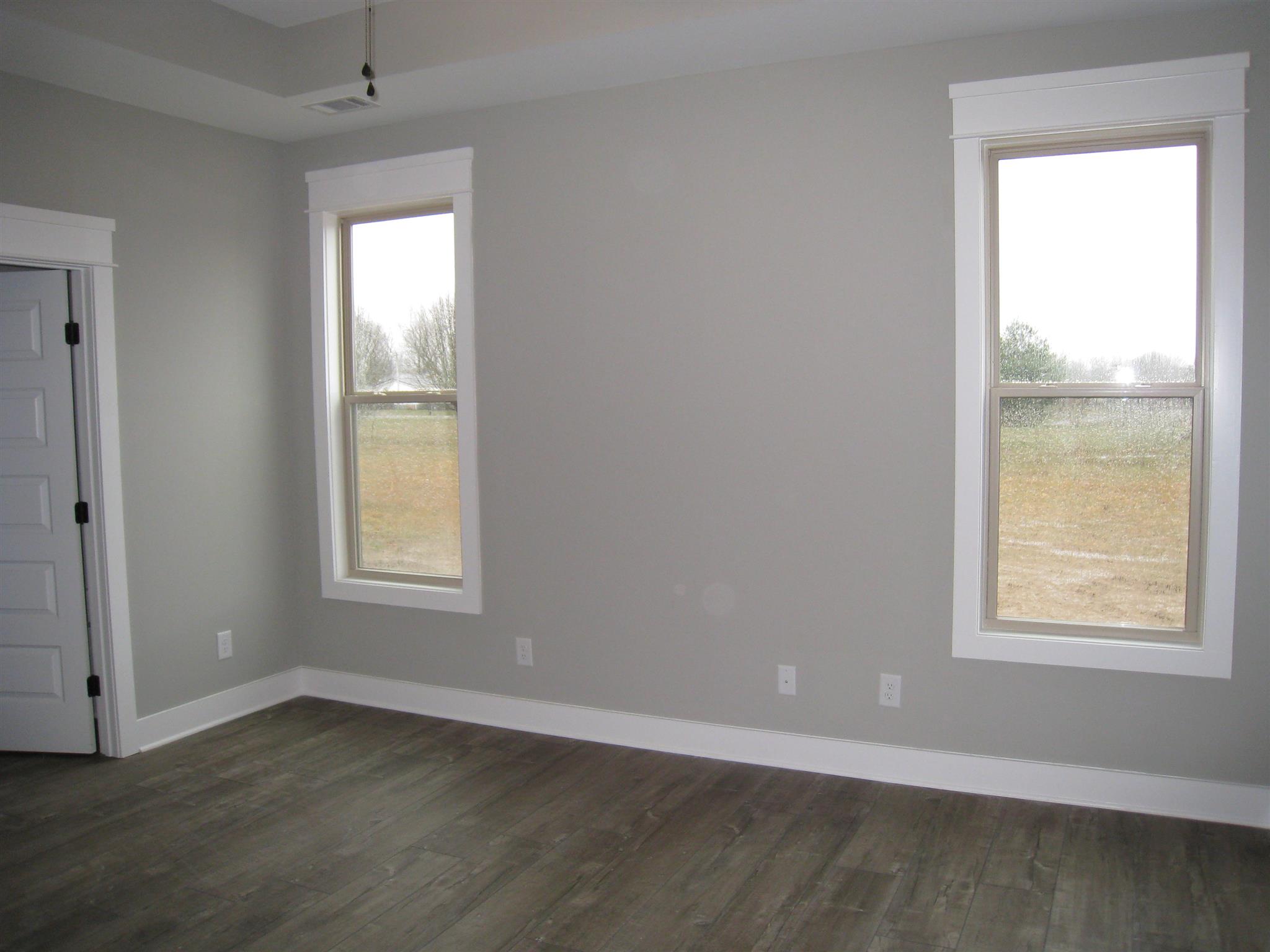 330 East Biggs Road Portland, TN 37148 - Photo 5 of 9 an empty room with wooden floor and windows