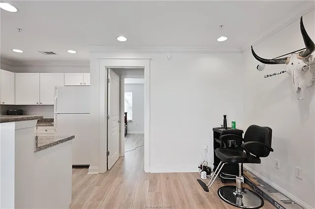 a view of a workspace with furniture and wooden floor