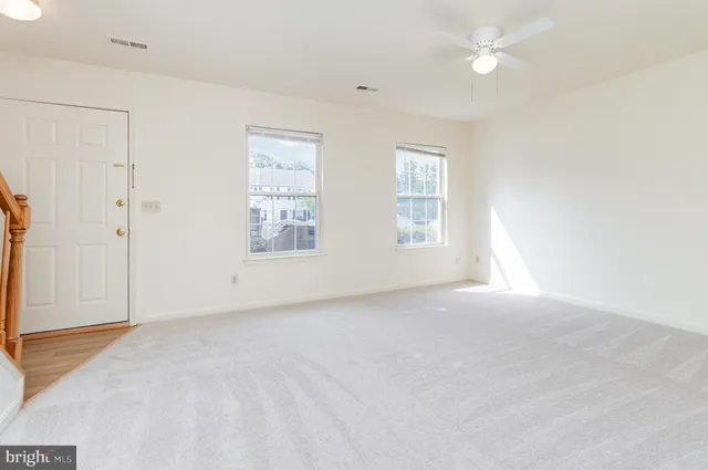an empty room with windows and closet