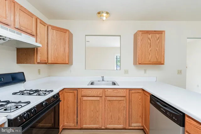 a kitchen with a sink stove and cabinets