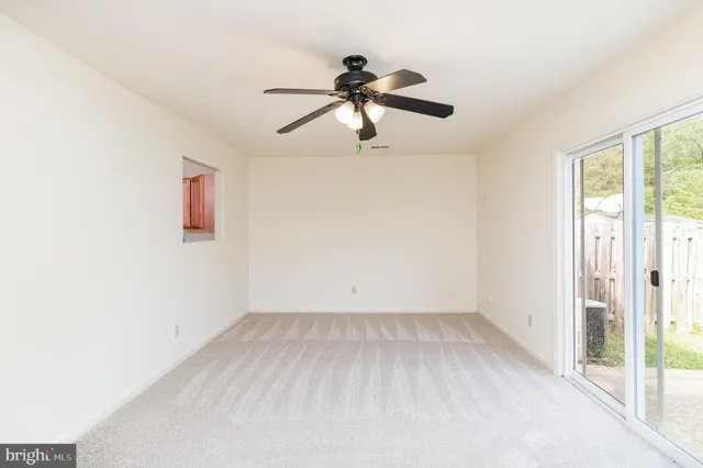 a view of room with window and ceiling fan