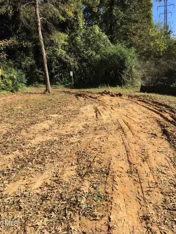 a view of a yard covered with snow in front of house