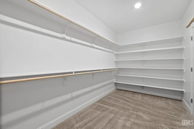 a view of a house with a yard and potted plants