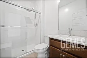 a kitchen with stainless steel appliances granite countertop a kitchen island hardwood floor and a sink
