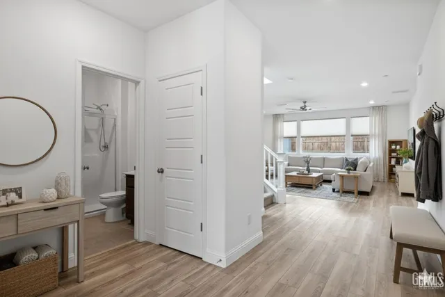 a view of a room with wooden floor and furniture