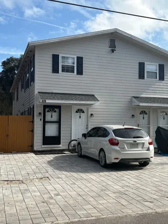 a view of a car parked in front of a house