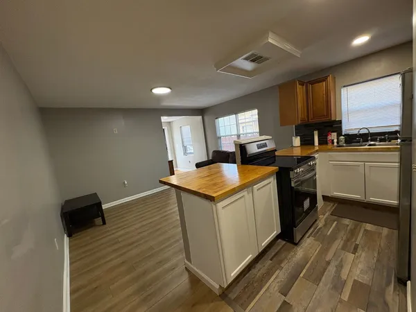 a kitchen with a sink appliances and cabinets