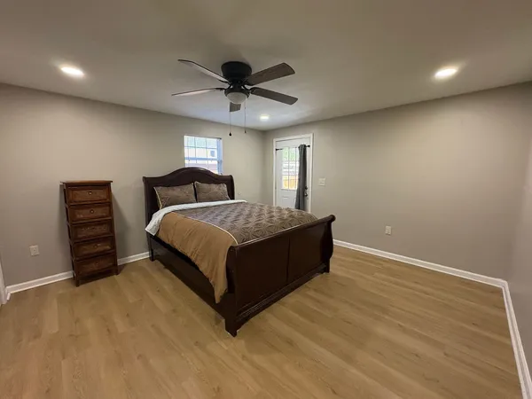 a spacious bedroom with a bed and a ceiling fan