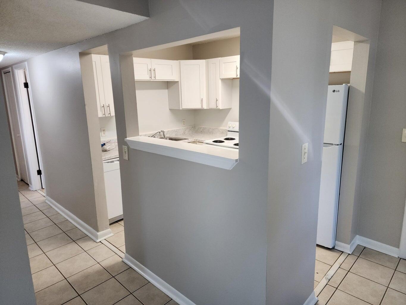 128 Smith Street Crestview, FL 32539 - Photo 4 of 13 a kitchen with stainless steel appliances a refrigerator and a sink