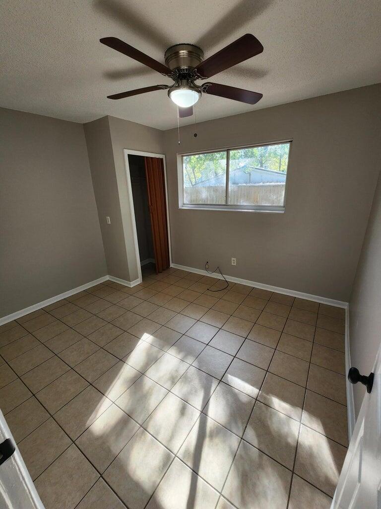 128 Smith Street Crestview, FL 32539 - Photo 9 of 13 a view of an empty room with a window