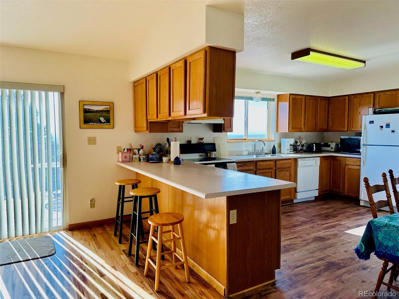 162 Cedar Ridge Road Mosca, CO 81146 - Photo 14 of 24 a kitchen with stainless steel appliances granite countertop a stove a sink and a refrigerator