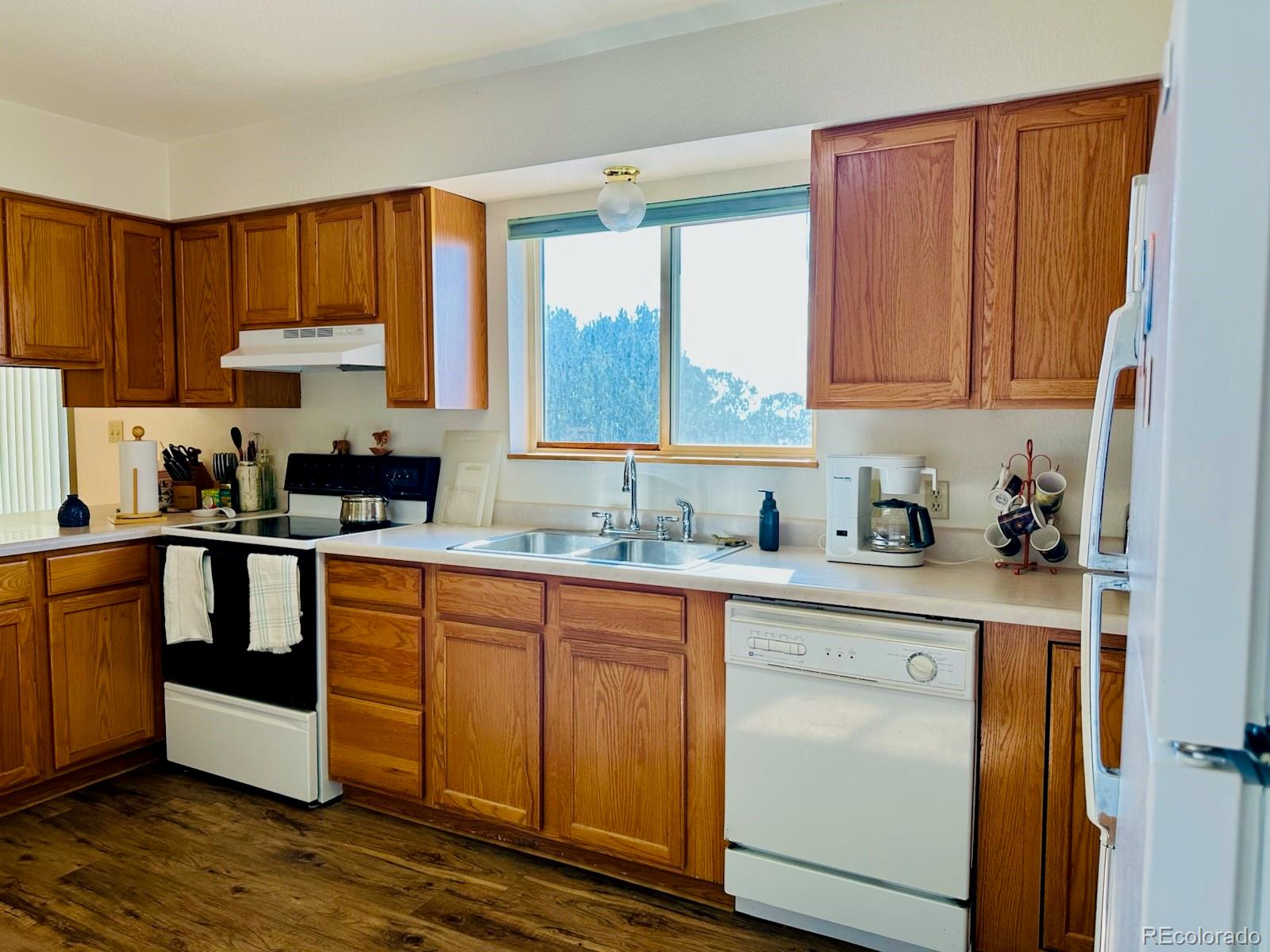 162 Cedar Ridge Road Mosca, CO 81146 - Photo 16 of 24 a kitchen with granite countertop wooden cabinets a sink and a stove