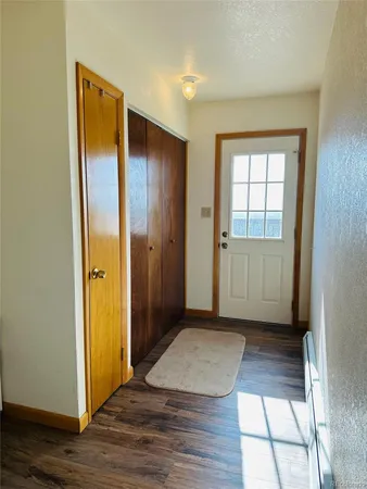 an empty room with closet and a window