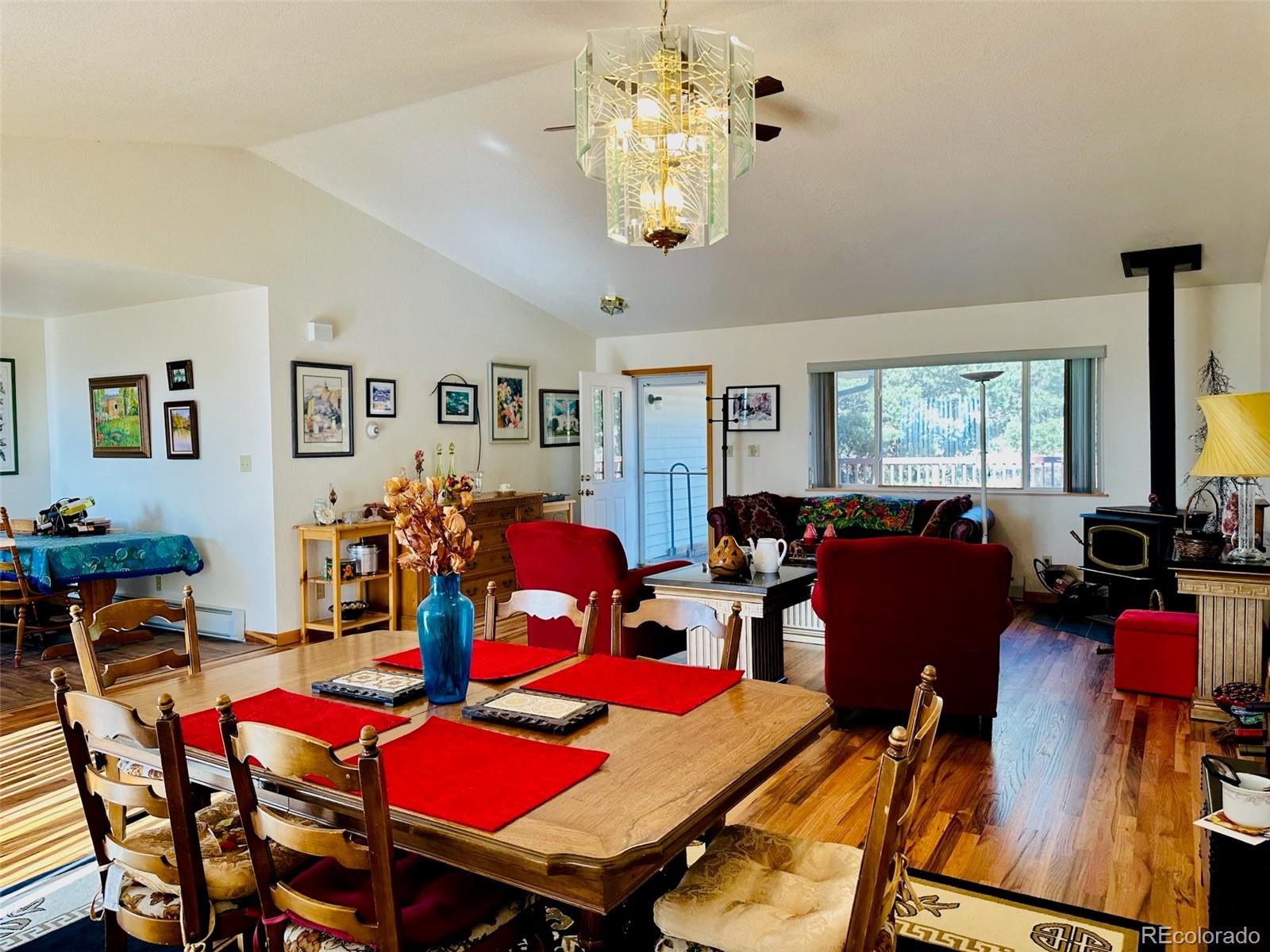162 Cedar Ridge Road Mosca, CO 81146 - Photo 5 of 24 a living room with lots of furniture and a chandelier