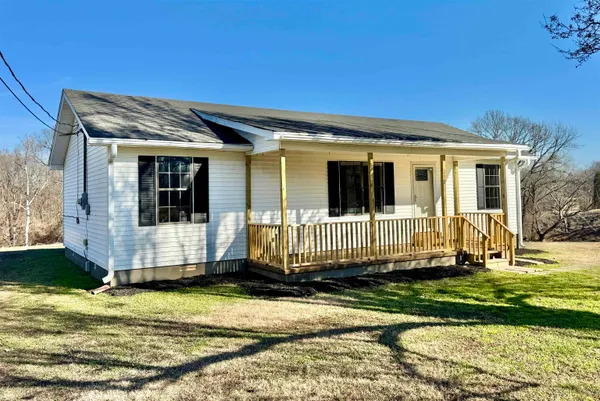 a view of a house with a yard in a patio