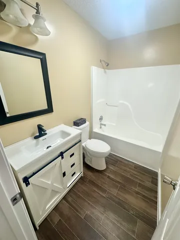 a bathroom with a double vanity sink mirror and toilet