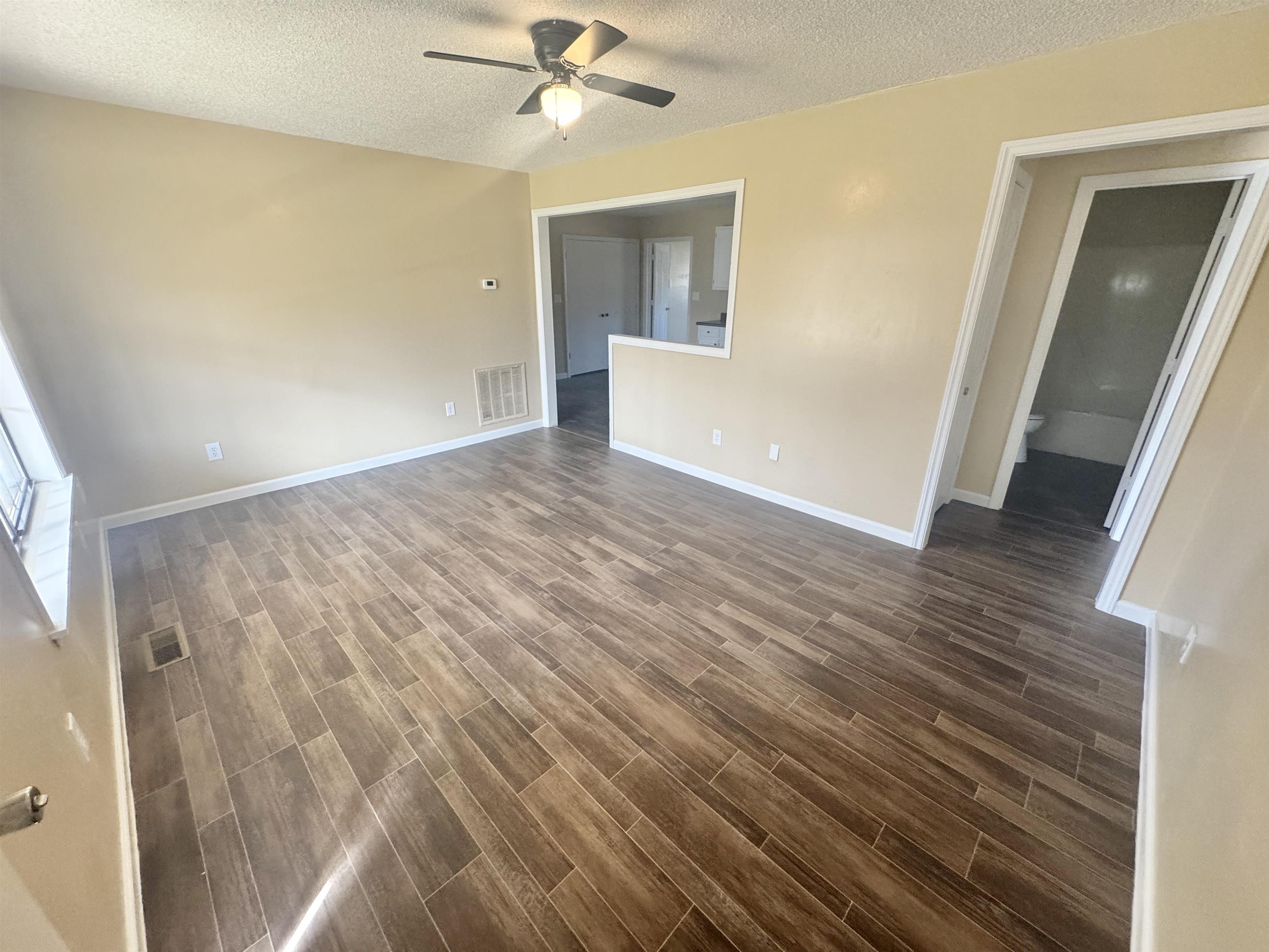 250 Dr Lewis Road Ripley, TN 38063 - Photo 14 of 18 a view of a livingroom with wooden floor and a ceiling fan