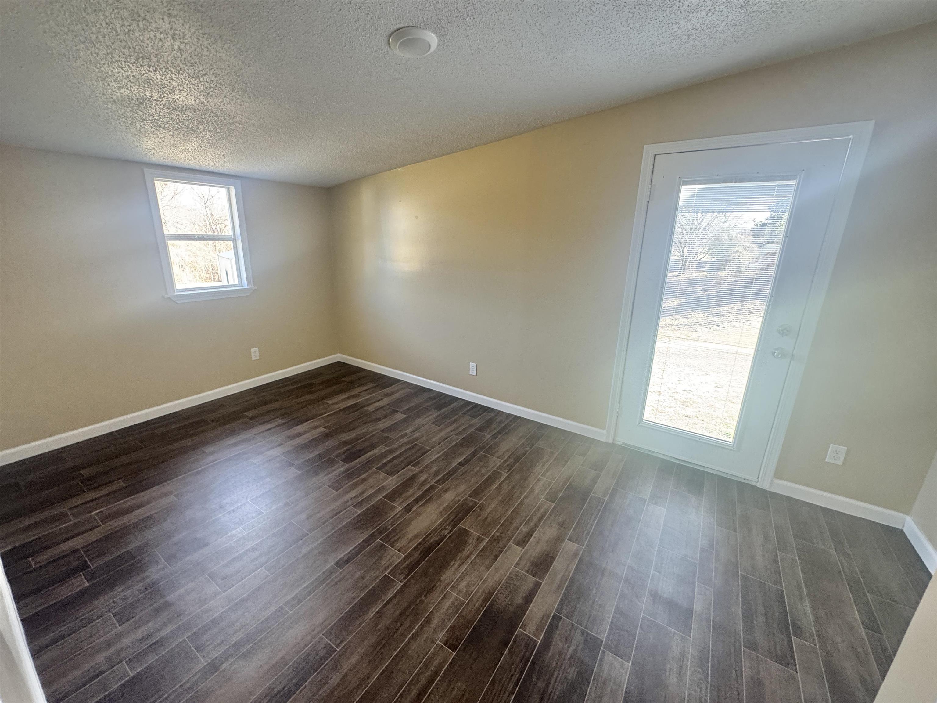250 Dr Lewis Road Ripley, TN 38063 - Photo 15 of 18 a view of an empty room with wooden floor and a window
