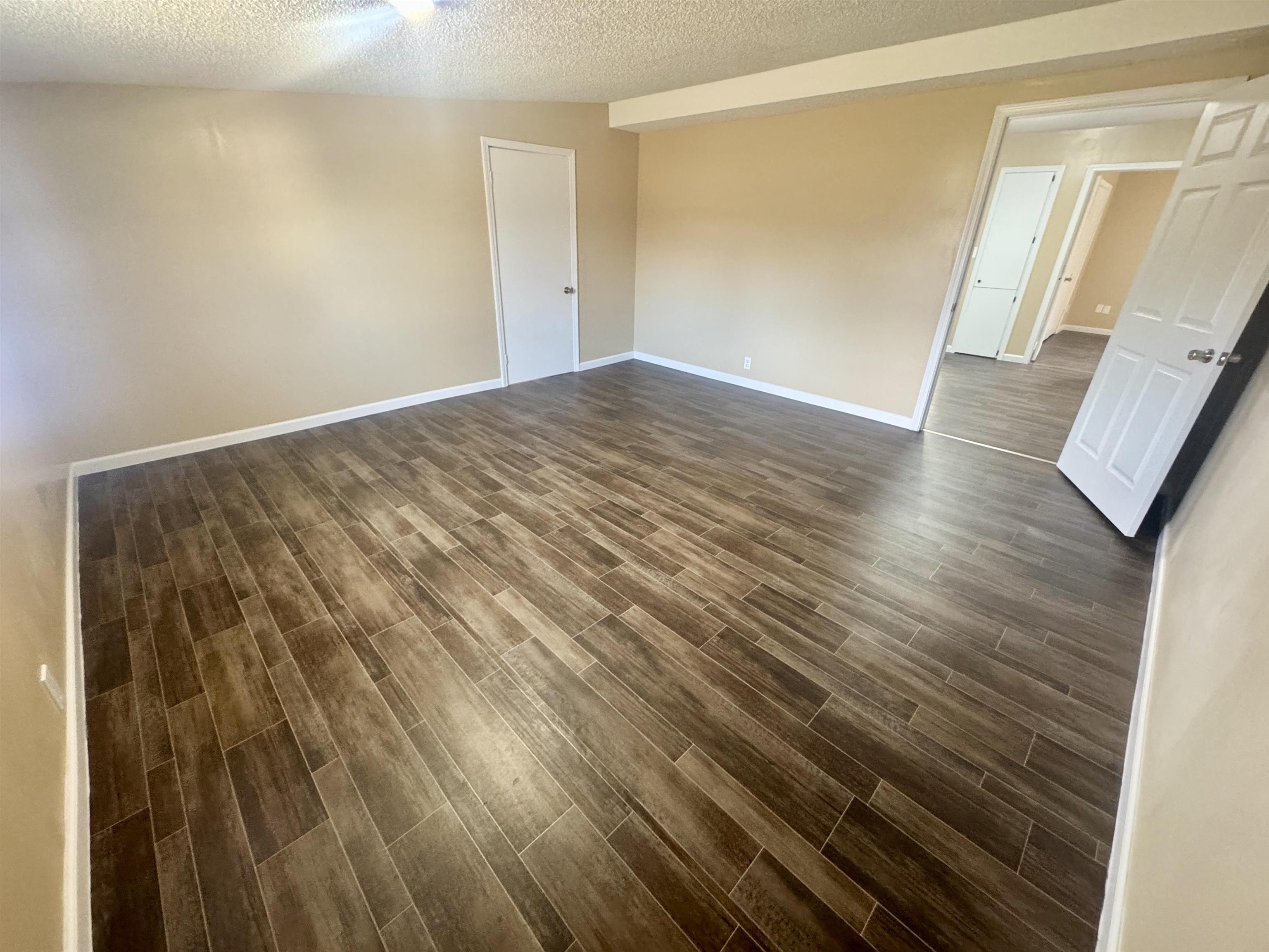 250 Dr Lewis Road Ripley, TN 38063 - Photo 16 of 18 a view of an empty room with wooden floor and a window