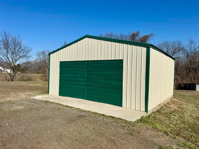 a view of a house with a backyard
