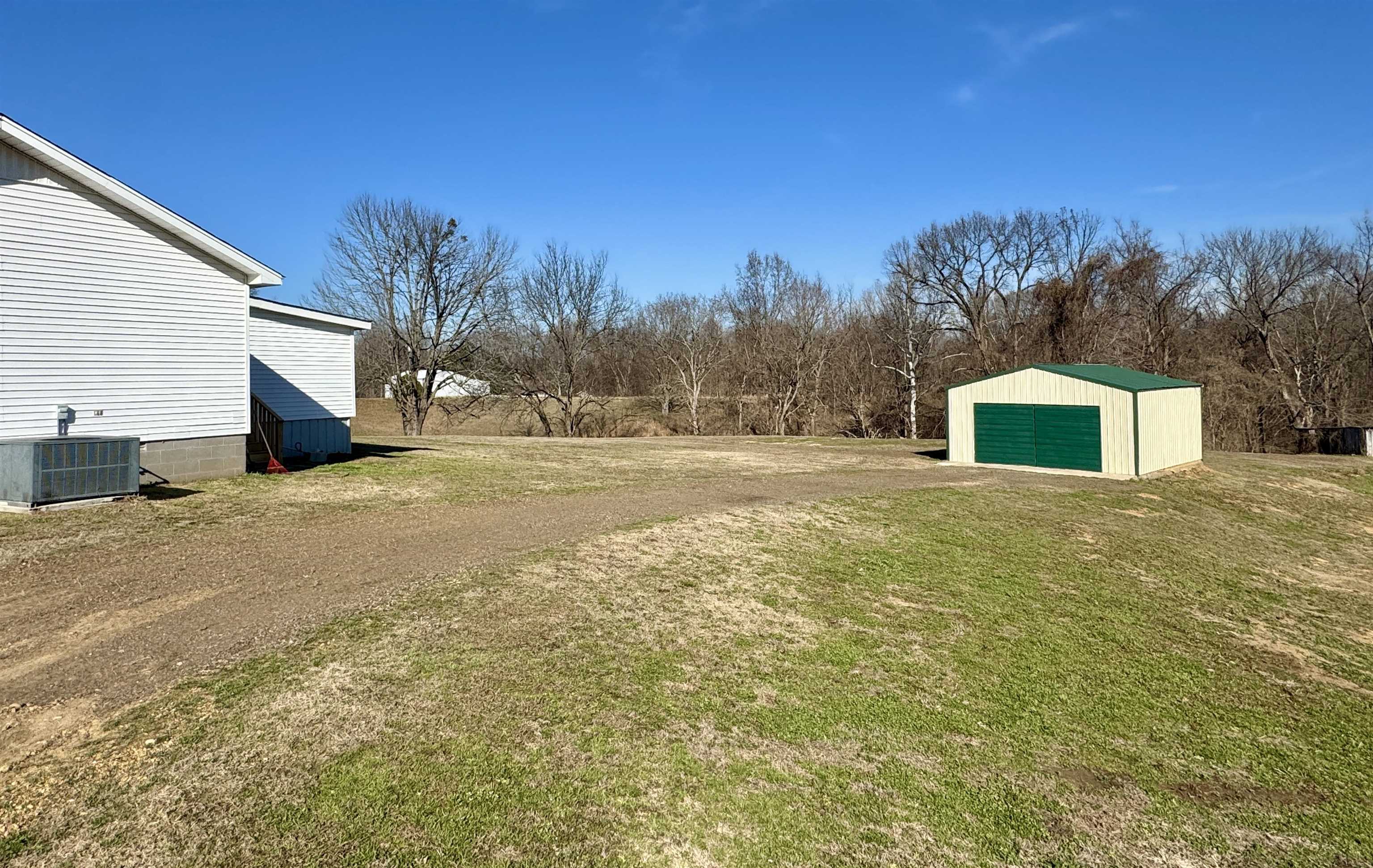 250 Dr Lewis Road Ripley, TN 38063 - Photo 3 of 18 a house with trees in front of it