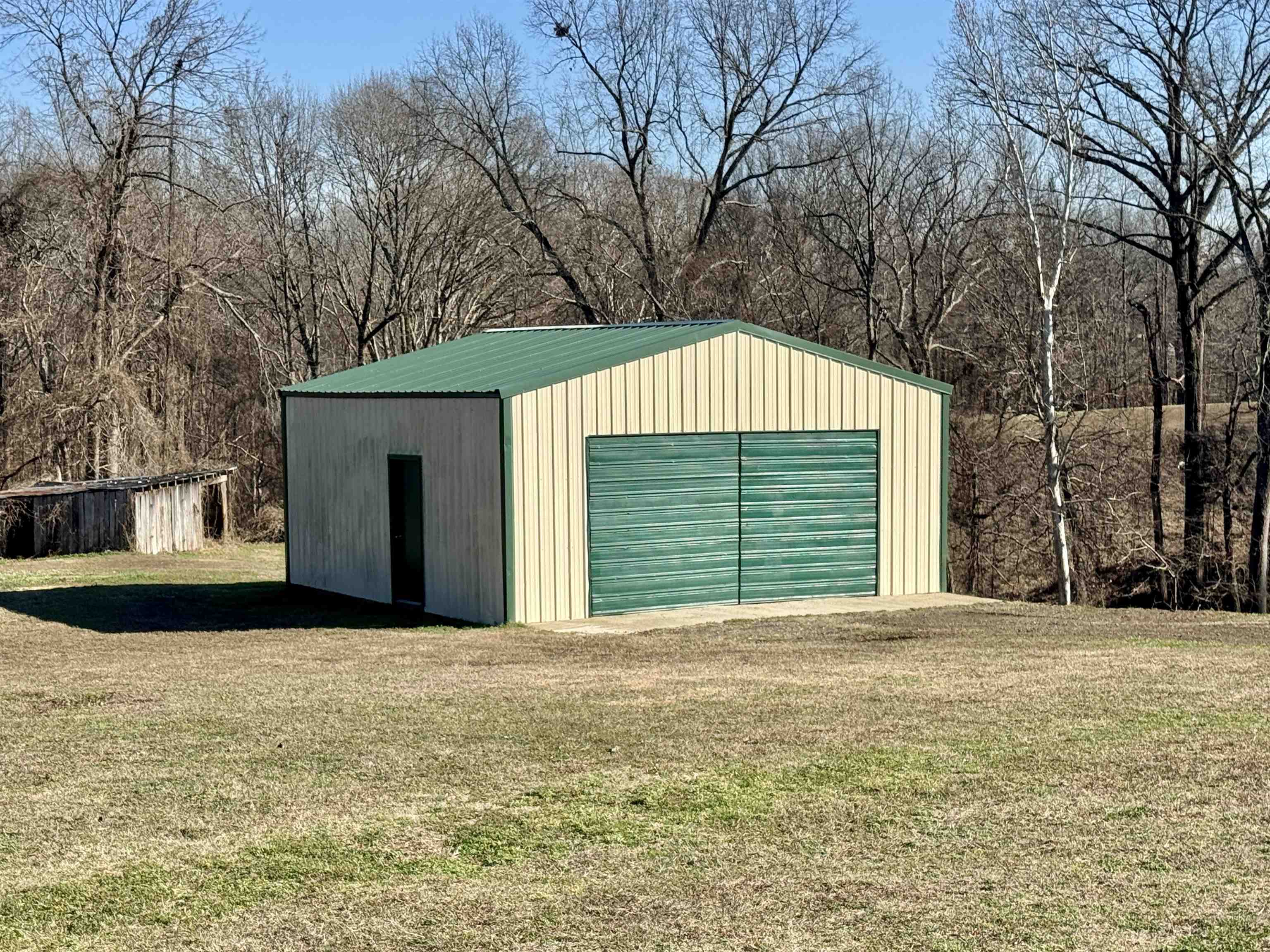 250 Dr Lewis Road Ripley, TN 38063 - Photo 5 of 18 a front view of a house with a yard and garage