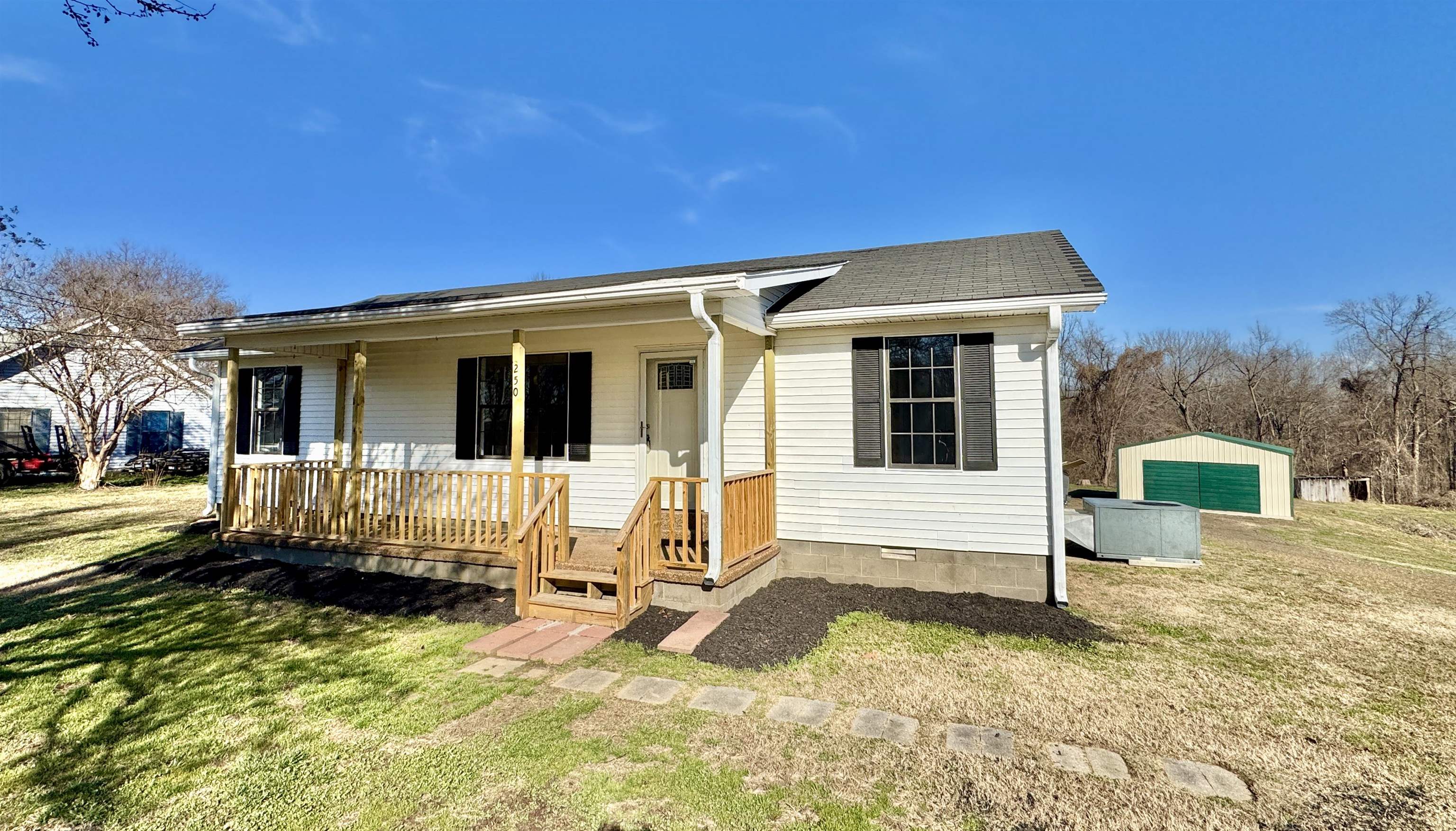 250 Dr Lewis Road Ripley, TN 38063 - Photo 7 of 18 a view of a house with a yard in the background