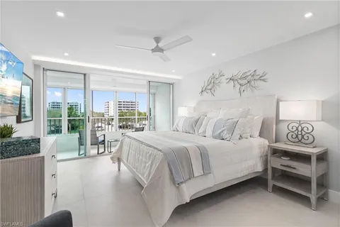 a bedroom with a large bed and a large window