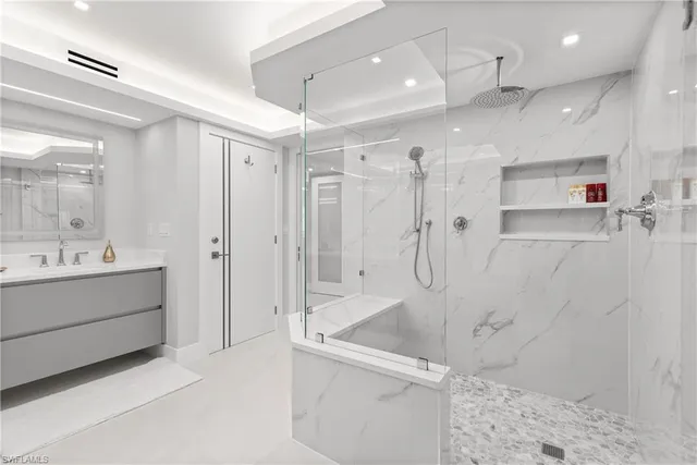a bathroom with a shower sink and mirror