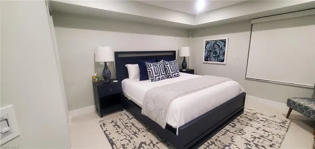 a bedroom with a bed and a night stand