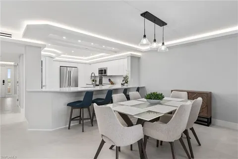 a view of a dining room with furniture and a chandelier