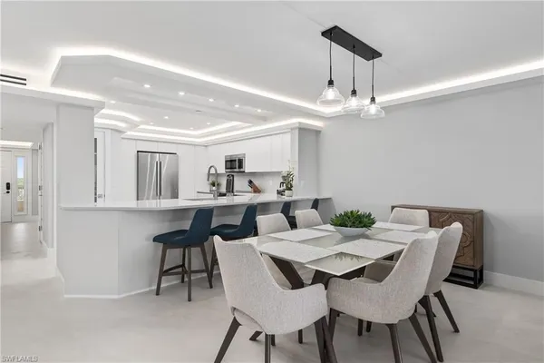 a view of a dining room with furniture and a chandelier
