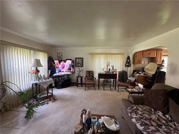a bedroom with furniture and a flat screen tv