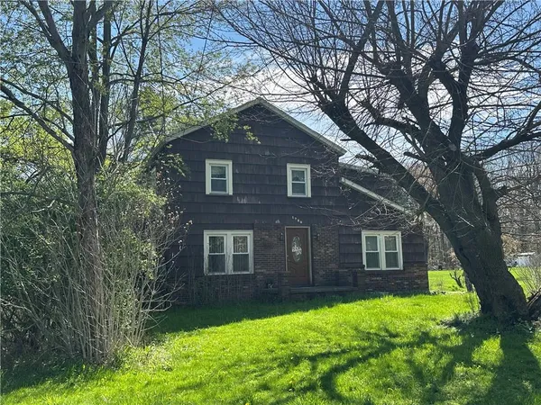 a view of a house with a yard porch and sitting area