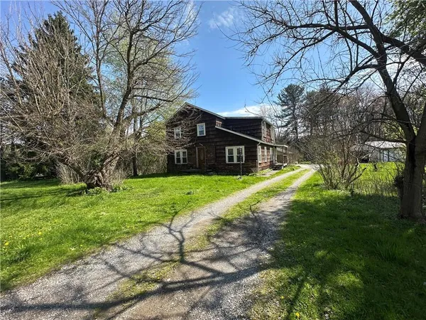 a view of a house with yard and tree s