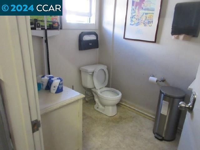 a white toilet sitting next to a bathroom sink