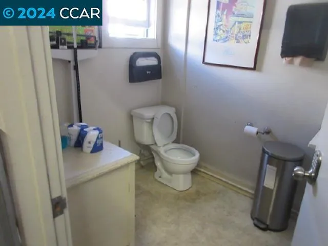 a white toilet sitting next to a bathroom sink