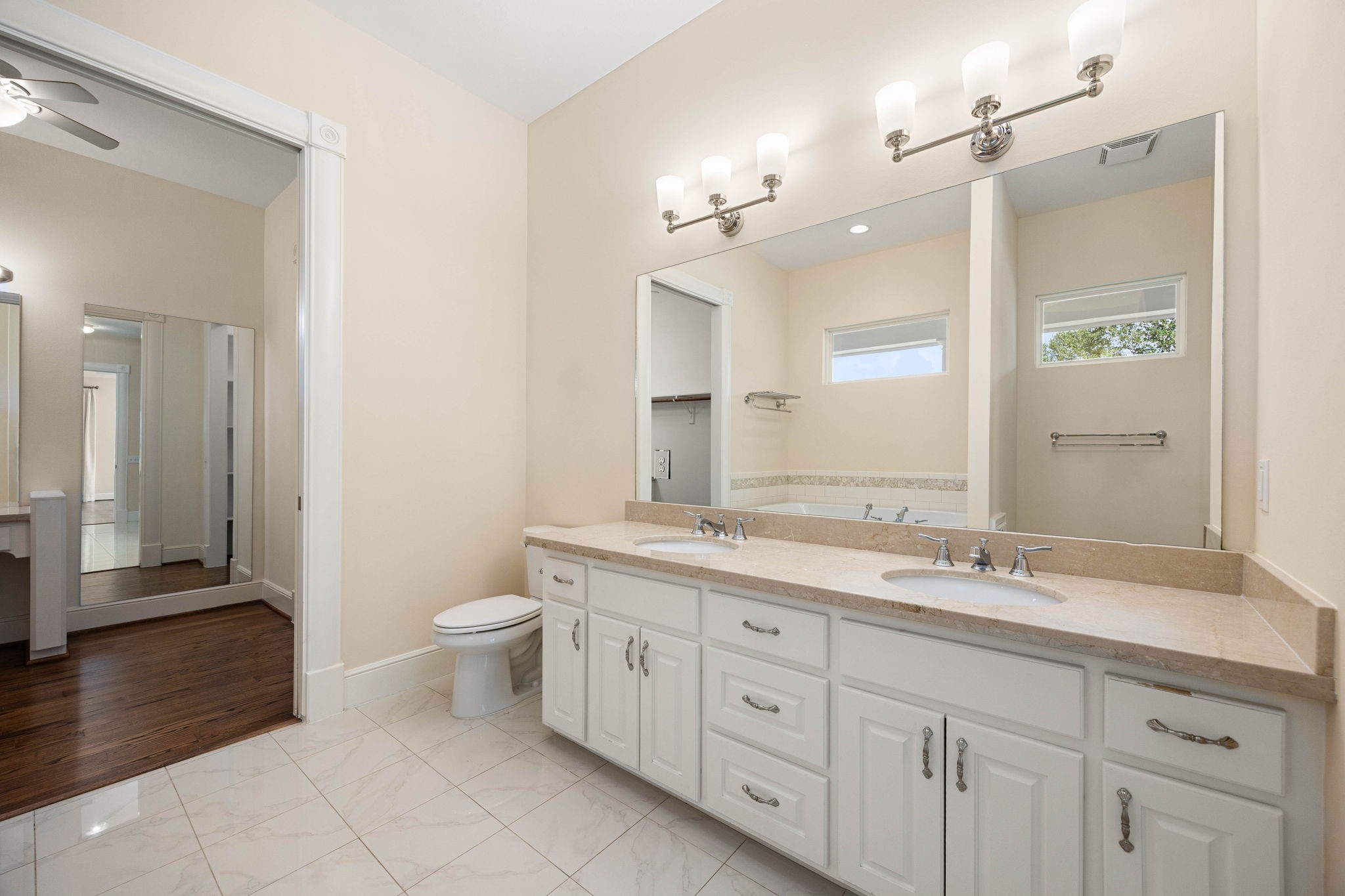 6039 Franz Road Katy, TX 77493 - Photo 21 of 49 The primary bath features a double-sink vanity, finished with polished nickel fixtures and a large mirrored wall for a bright, spa-like feel.