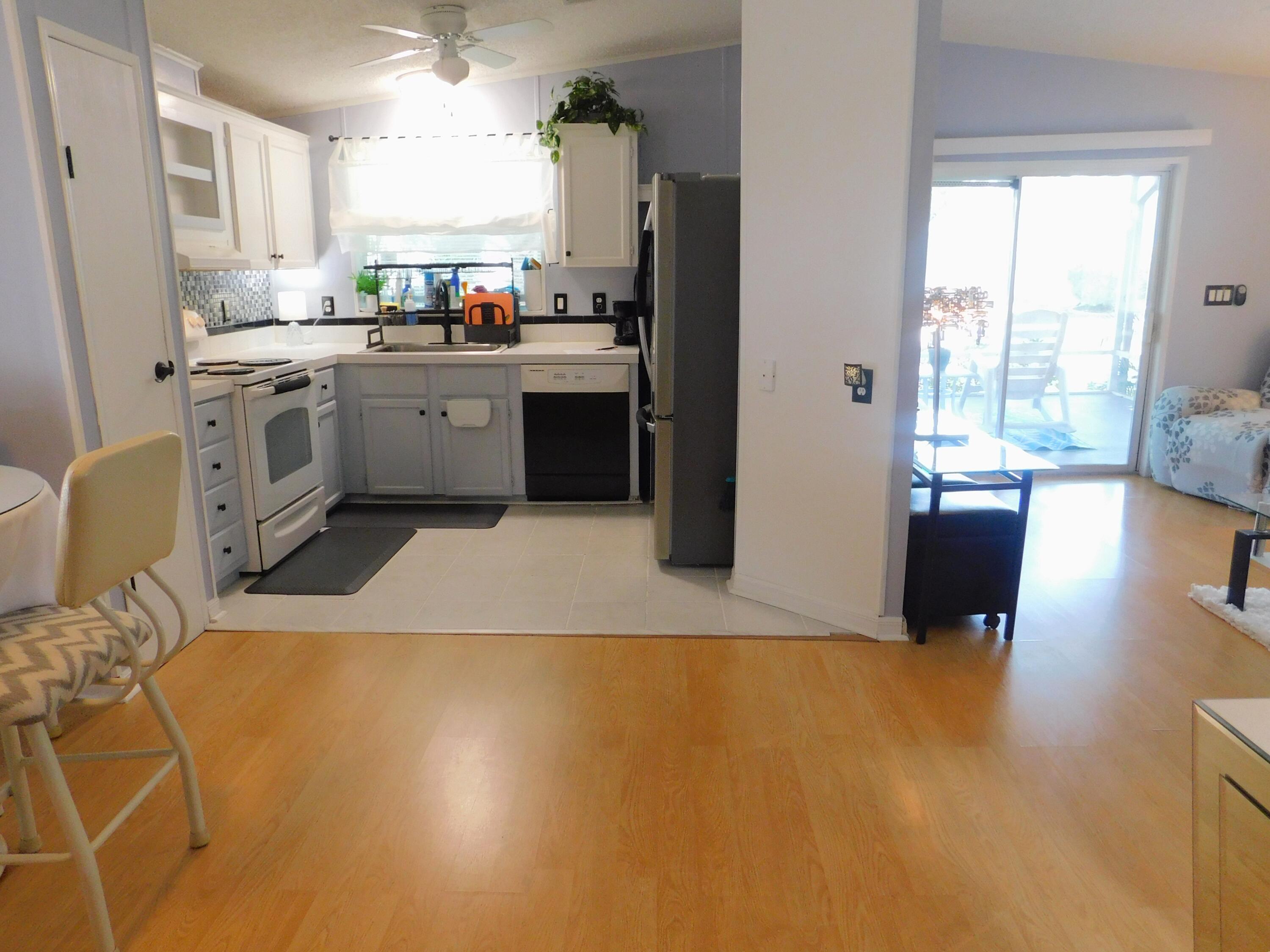 376 Seahorse Terrace Fort Pierce, FL 34982 - Photo 6 of 16 a kitchen with stainless steel appliances a stove a sink a refrigerator and cabinets