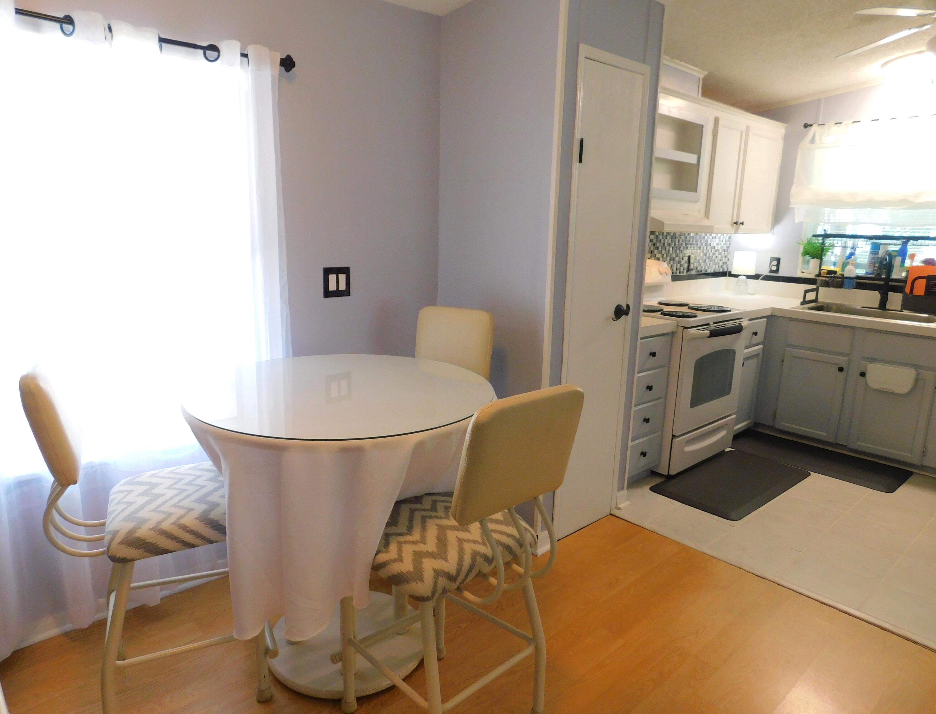 376 Seahorse Terrace Fort Pierce, FL 34982 - Photo 7 of 16 a kitchen with a chair and white appliances