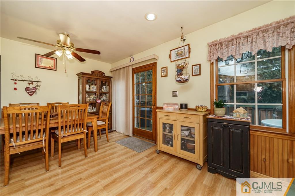 369 Amherst Road Linden, NJ 07036 - Photo 8 of 23 a kitchen with stainless steel appliances granite countertop a stove a sink dishwasher and a dining table with wooden floor
